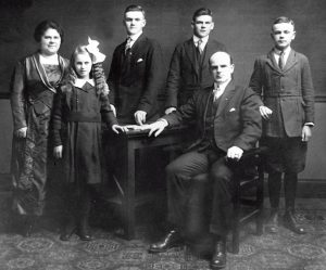 Historical photo of a family of 6, formally dressed.