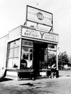 Black and white photograph of a historic-looking gas station that says R. Gagne Auto Supply Battery Service
