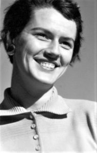 Black and white photo of a smiling woman.